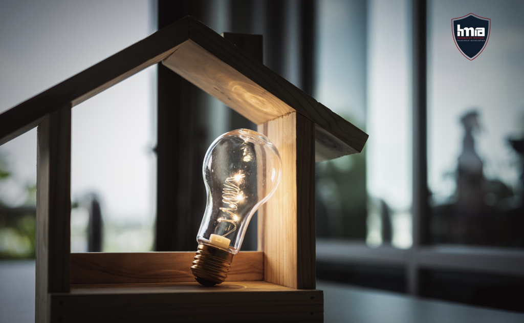 Lightbulb lighting up the inside of a hollow wooden home